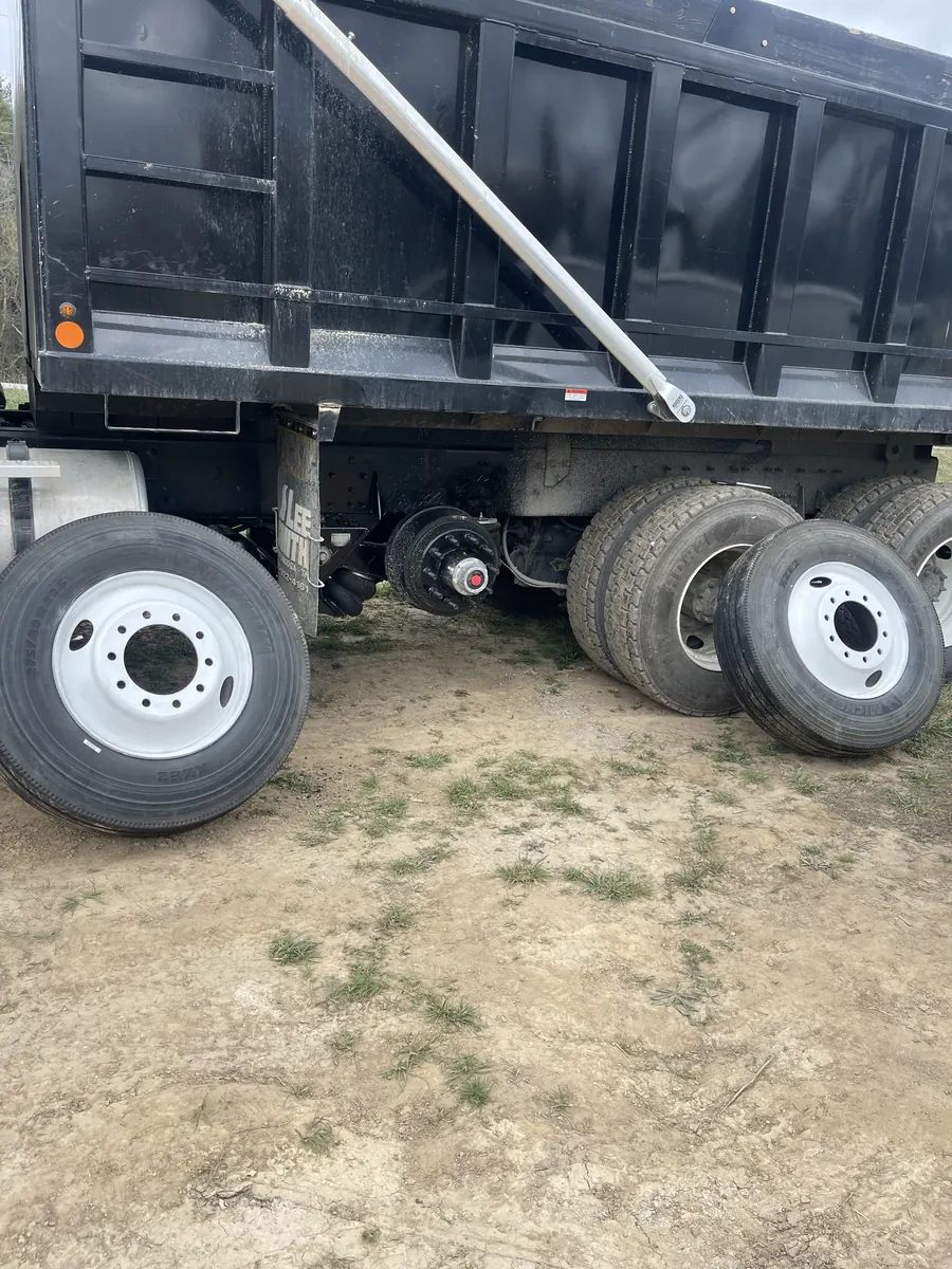 Black dump truck rolling out on a new set of tires